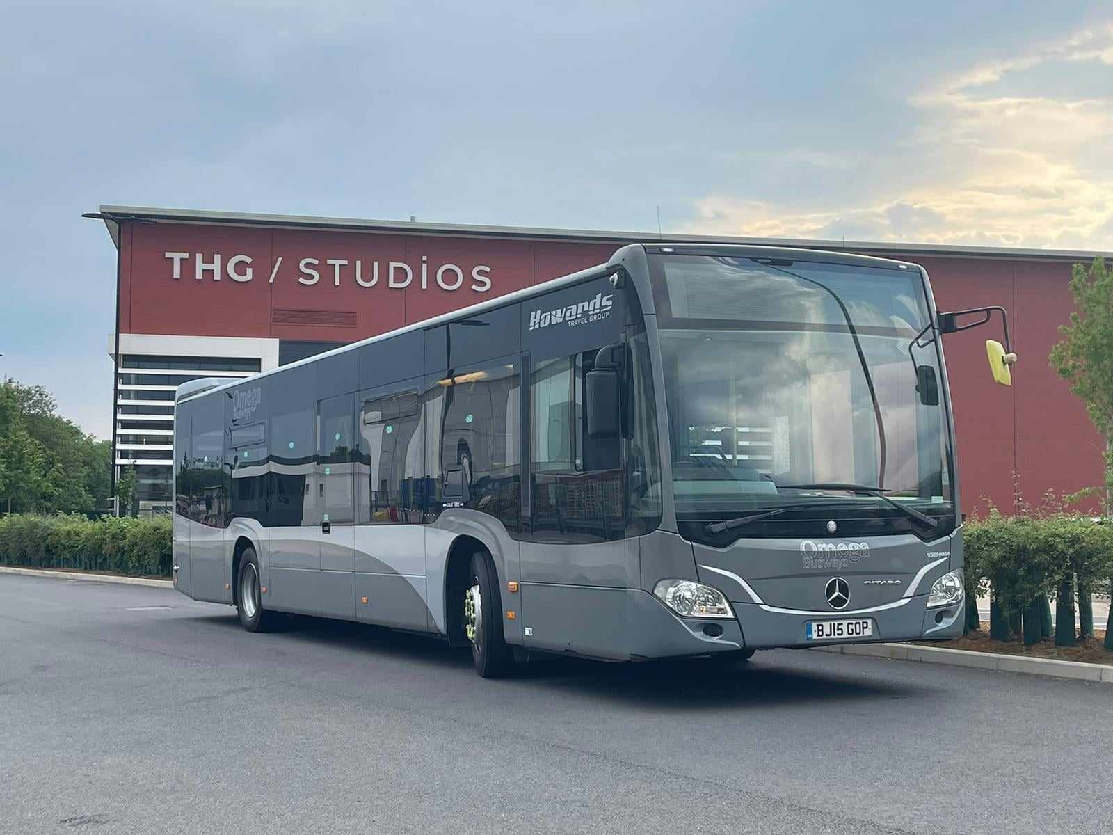 An Omega Busways bus parked outside THG Studios in Manchester, UK.